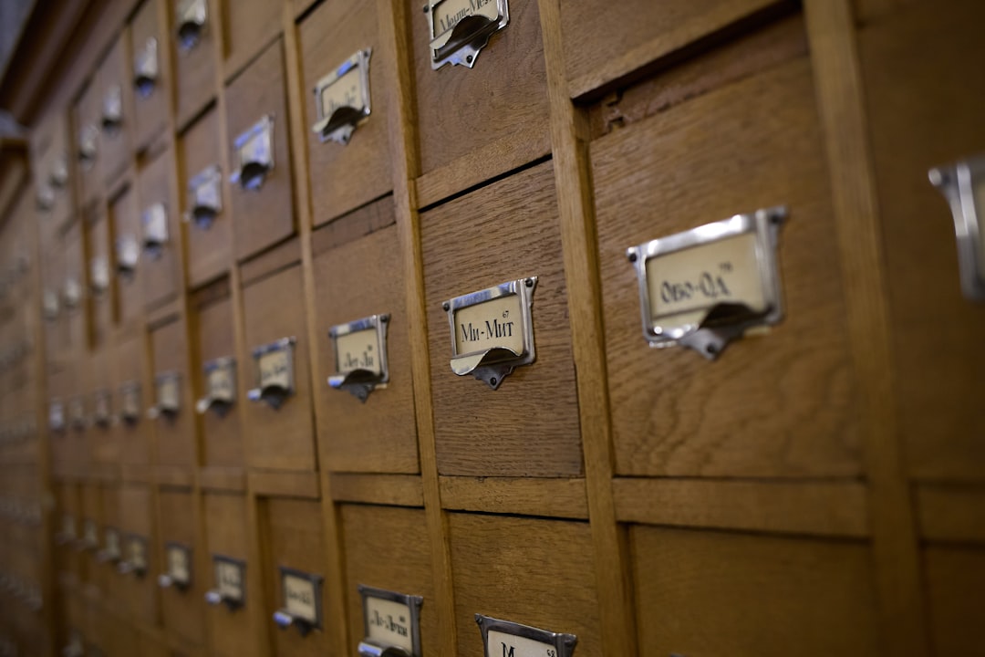 Wooden card catalog drawers with metal labels